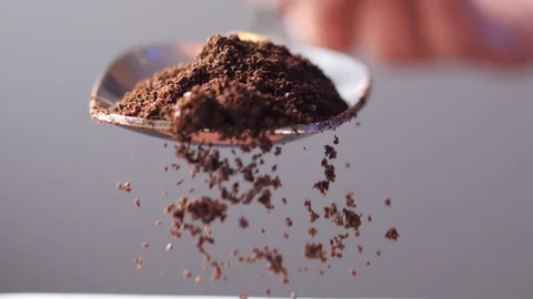 Ground Coffee being shaken off spoon Video stock 99124706