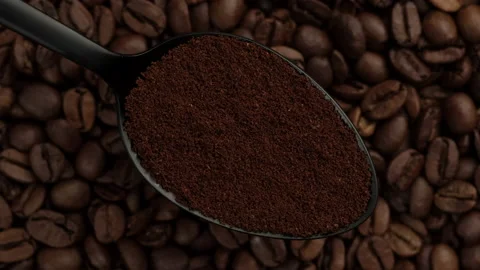 Ground coffee in black spoon and coffee beans on background rotating Stock-Footage 135658136
