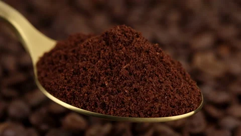 Ground coffee in black spoon and coffee beans on background rotating Stock Footage 148802804