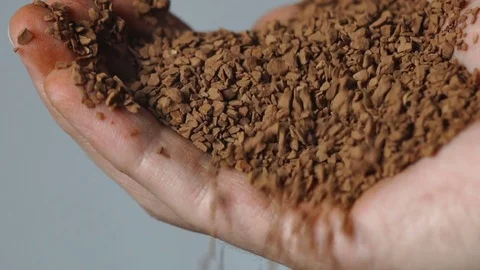 Ground coffee close-up in the men's hand Stock Footage 72251583
