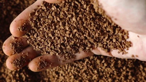 Ground coffee close-up in the men's hand Stock Footage 72251730
