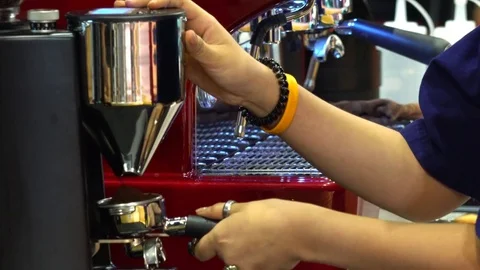 Ground coffee coming out from coffee grinder to portafilter Stock Footage 73608351