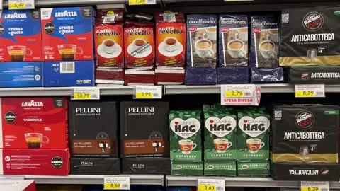 Ground coffee displayed on shelf, tilt down on packs Stock Footage 283213660