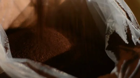 Ground coffee falling into a bag at a packaging plant Stock Footage 43199389