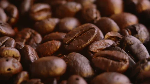 Ground coffee falling on roasted coffee beans background. Organic coffee seeds. Stock Footage 157085404