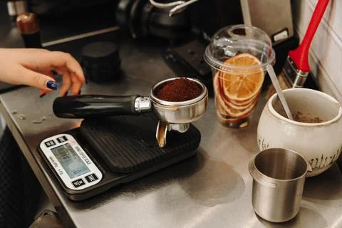 Ground coffee is measured on a digital scale before tamping and brewing espre Stock Photos