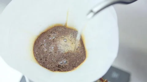 Ground coffee is poured by boiling water Stock Footage 63144648
