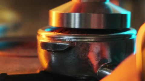 Ground coffee is pressed in a holder. Slow motion. Stock Footage 183128279
