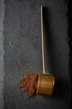 Ground coffee in a scoop dark background Stock Photos