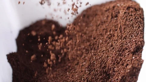 Ground Coffee sprinkling into white bowl Video stock 99123768