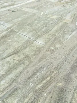 Ground covered with sand showing patterns from movement, taken during dayli.. Stock Photos