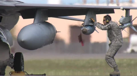 Ground Crew checking bombs on aircraft Stock Footage 32591860