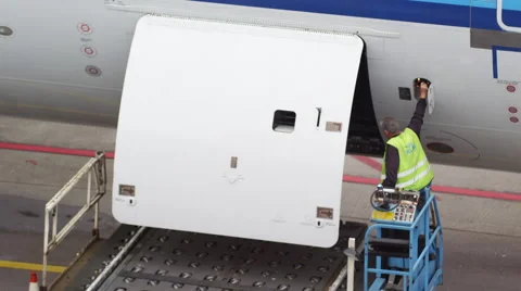 Ground crew closing the cargo door for this big airplane Stock Footage 45998749