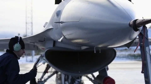 Ground crew placing remove before flight tags on F-16 Fighting Falcon Stock Footage 97443558
