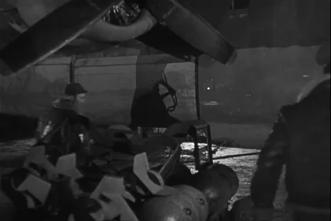 Ground crew prepare to load explosives in fighter aircraft - 1944 Stock Footage 108319339