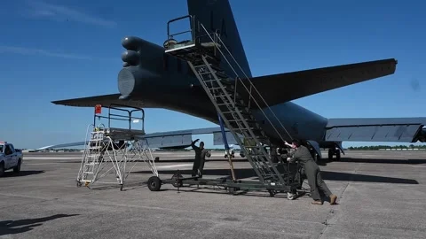 Ground crew pushing mobile steps towards B-52 Stratofortress Stock Footage 272587793