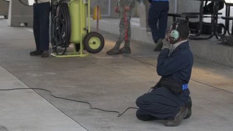 Ground crew speaking through headphones  Stock Footage 98028883