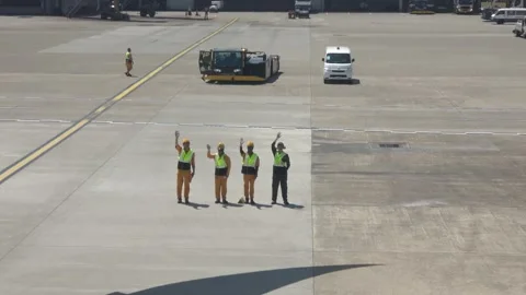 Ground crew waving to departing plane, Taipei, Taiwan, May 24, 2025. Stock Footage 335737009