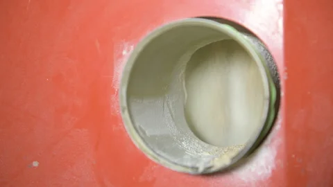 Ground flour is pouring from a mill that grinds whole grain wheat at a mill Stock Footage 173469860