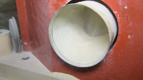 Ground flour is pouring from a mill that grinds whole grain wheat at a mill Stock Footage 173474276