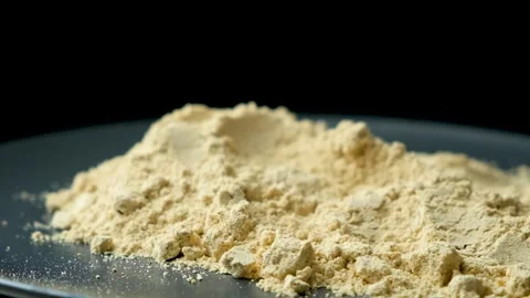 Ground ginger as a fine dry powder, macro rotation on a black background Video stock 276479749