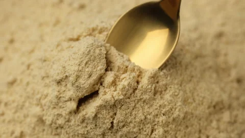Ground ginger powder in spoon. Condiment or dietary supplement Vídeos de archivo 260395896