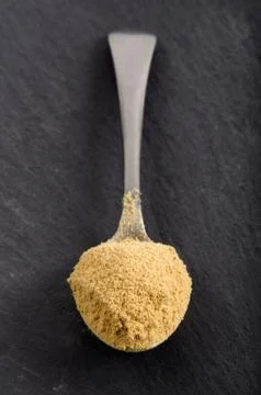 Ground ginger powder on a spoon Stock Photos