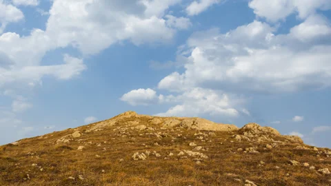 Ground hill on a blue clouds background time lapse scene Stock Footage 307233696