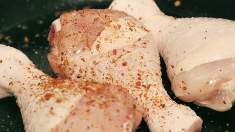 Ground Hot Chili Pepper on Raw Chicken Legs Stock Footage 148190090