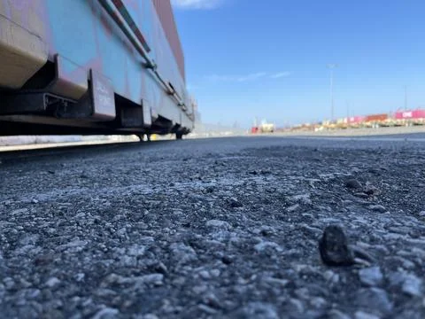 Ground Level Up Close Rail Yard Railroad Tracks with Blue Skies Concrete Stock Photos