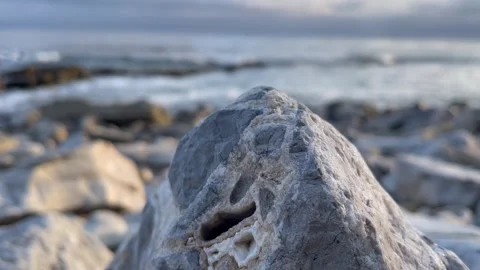 Ground Level Closeup of Rocky Beach with Pacific Ocean in Background Stock Footage 244094067