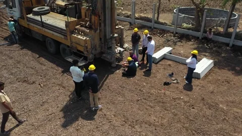 Ground-level drone angle focusing on engineering crew members Stock Footage 337195311