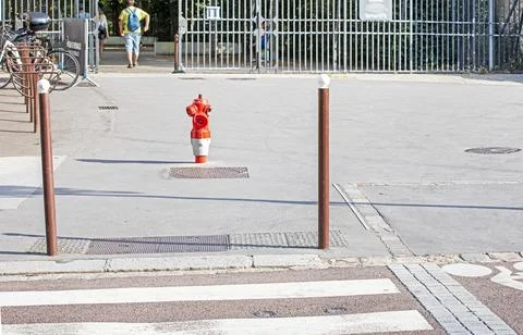 A ground-level fire hydrant on the asphalt in the city at a crosswalk and n.. Stock Photos