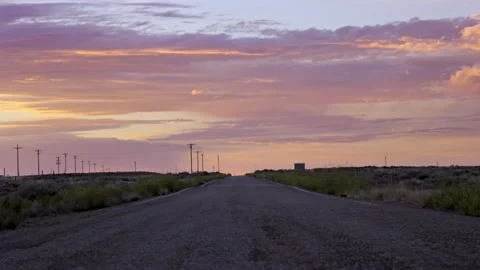 Ground level low angle view of straight dirt road during breathtaking sunrise 스톡 동영상 202203062