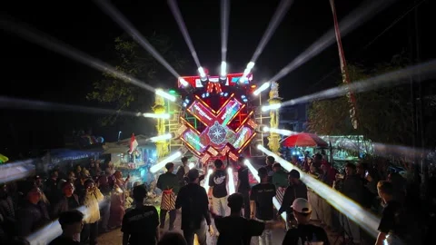 Ground Level Night Carnival With Pulsing LED Light Wheel Stock Footage 345148701