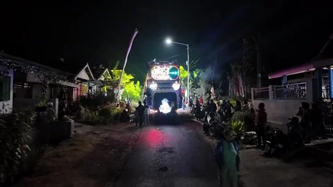 Ground level night carnival street parade with illuminated neon truck Stock Footage 345201641
