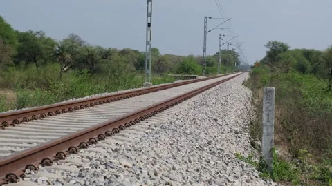 Ground-level perspective of a straight railway track Видео 329561186