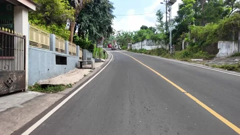 Ground Level POV Along Curving Indonesian Village Road Stock Footage 345151769