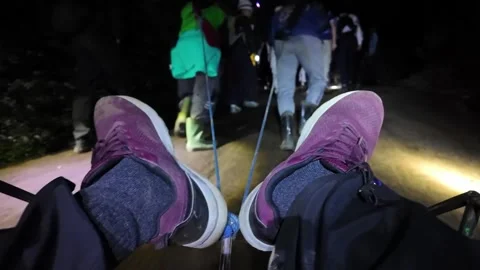 Ground level POV of local human pulled trolley to Ijen crater at night Видео 345155336