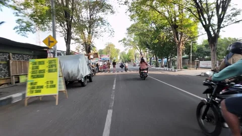 Ground Level POV Ride Through Tree Lined Lumajang Street Stock Footage 345195999