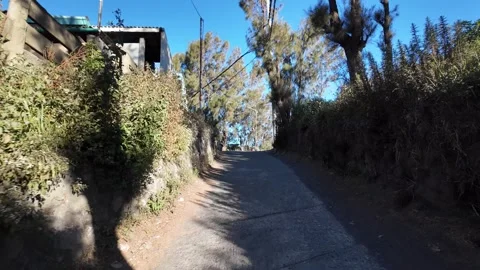 Ground Level POV Uphill Lane Through Sukapura Village Stock Footage 345195293