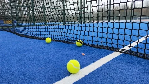 Ground level shot of balls hitting the net of a paddle tennis court Stock-Footage 170452787