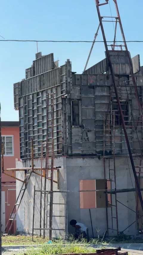 Ground level shot of a man doing construction working on a residential house Stock-Footage 332613272