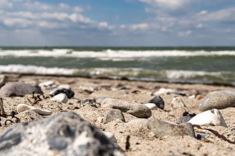 Ground level shot of a sandy beach overlooking the sea. Low depth of damage Stock Photos