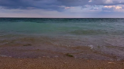 Ground level shot of sea waves coming to shore. Camera pans to right Stock Footage 93123921