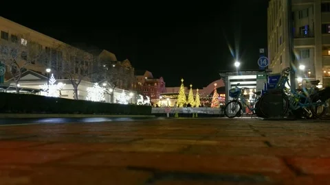 Ground level shot of the a skating rink at night with Christmas trees in Atlanta Stock Footage 226681616