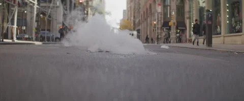 Ground Level Show of Steam Rising From a New York City Manhole Stock Footage 208760841