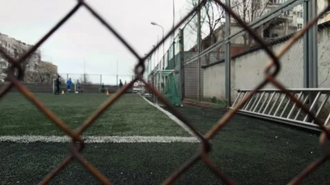 Ground Level Tracking Shot Behind Rusty Mesh Fence Focused on Metal Texture.. 스톡 동영상 332155508