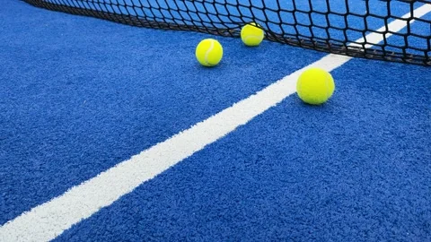 Ground level video of balls bouncing near the net on a paddle tennis court Stock Footage 170452779