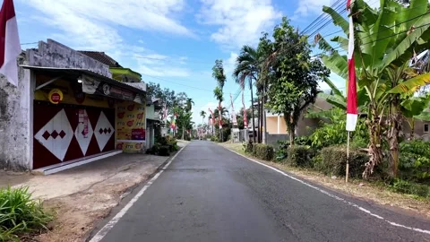 Ground Level View Along Flag Lined Indonesian Road Stockbeeldmateriaal 345143145